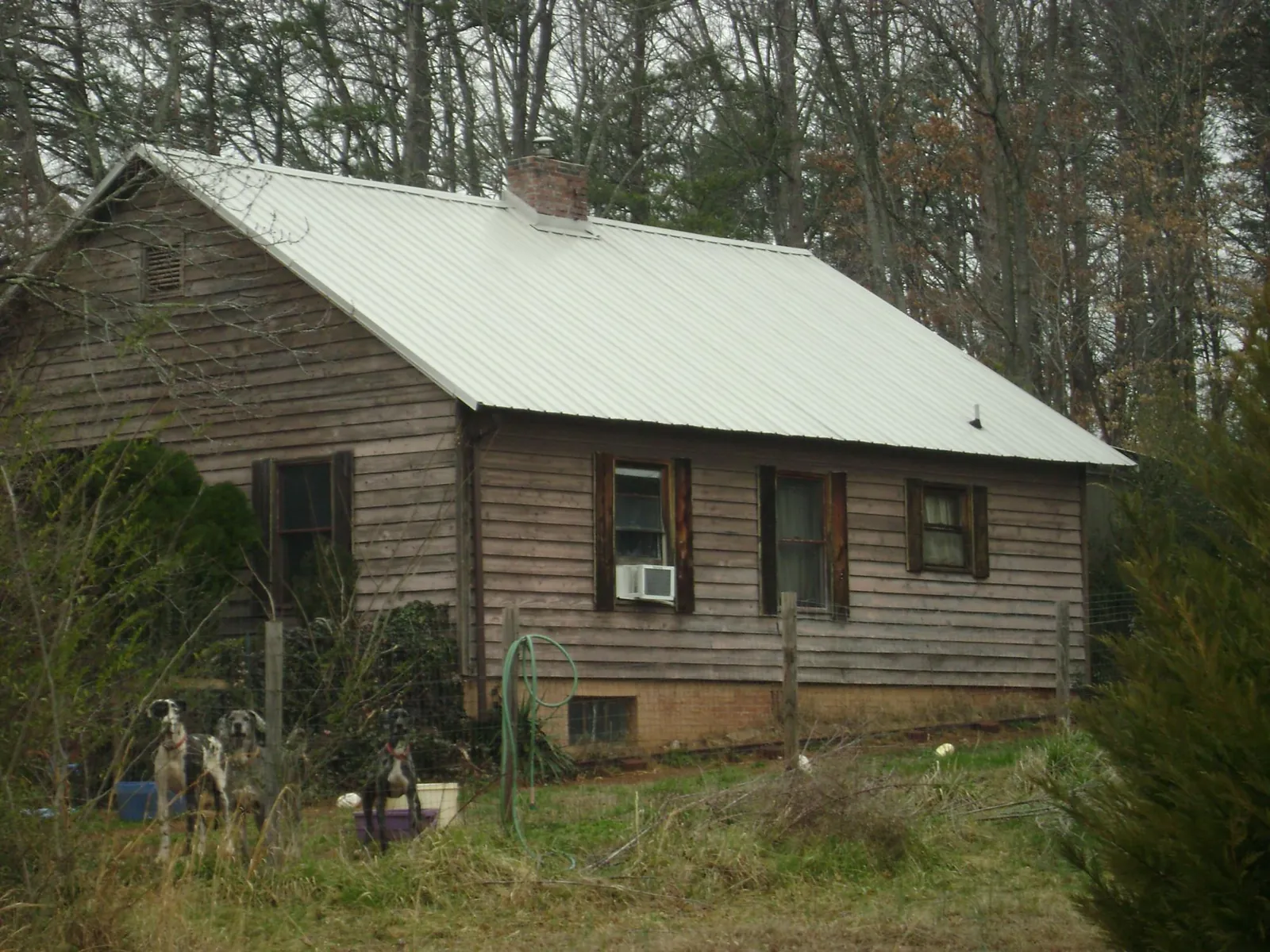 White metal roof on an old wood sided farmhouse, from a Metal Roof Installation job in Wilkesville